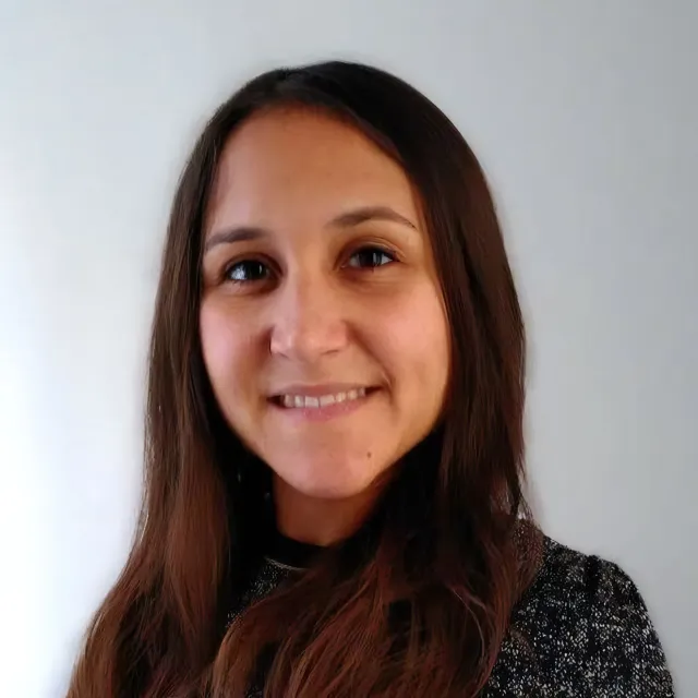 Headshot of a woman smiling in front of a white background